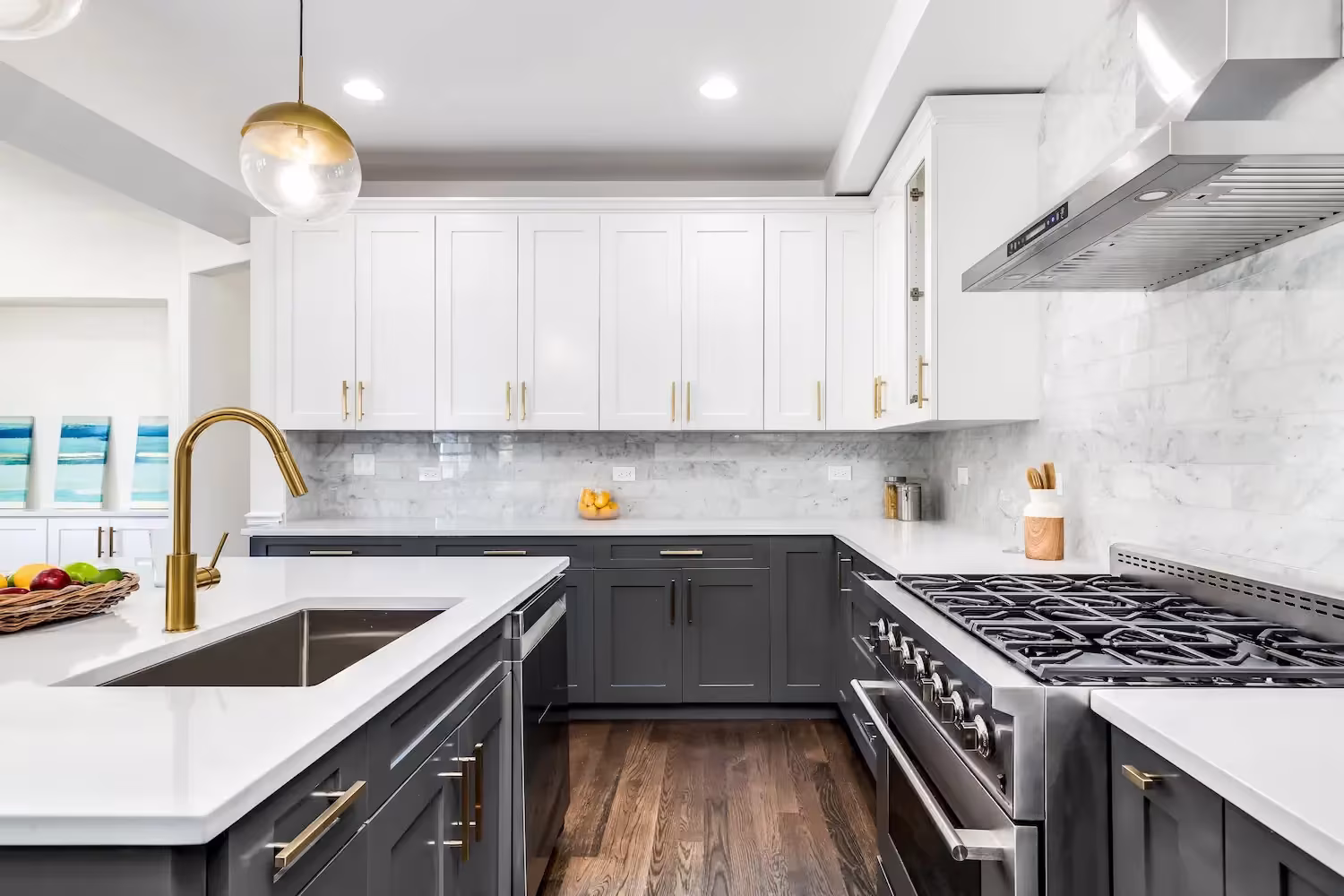 White uppers over dark gray base cabinets with a brass faucet in St Charles
