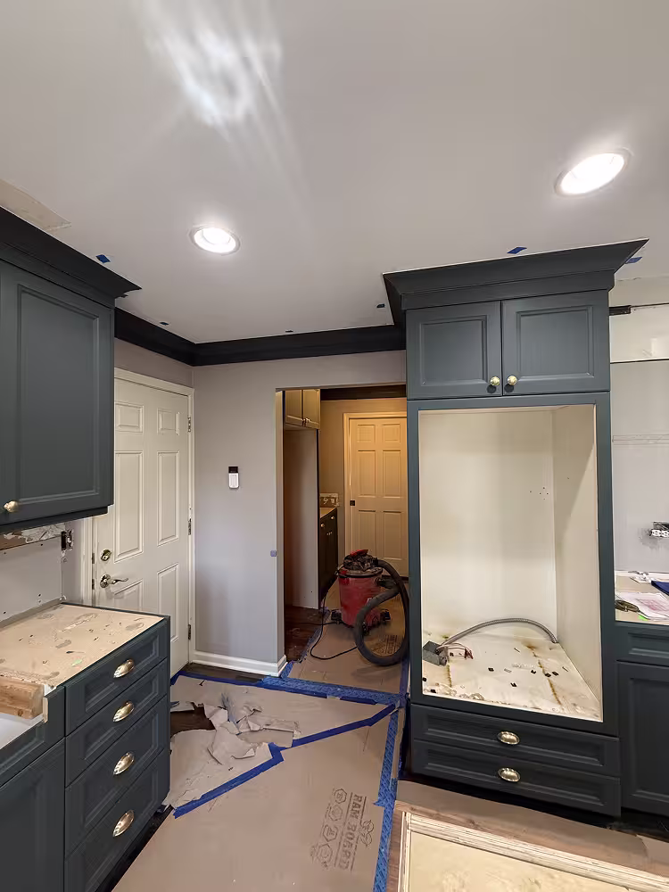 Dark charcoal Shaker cabinets and crown molding replacing the cream raised panels