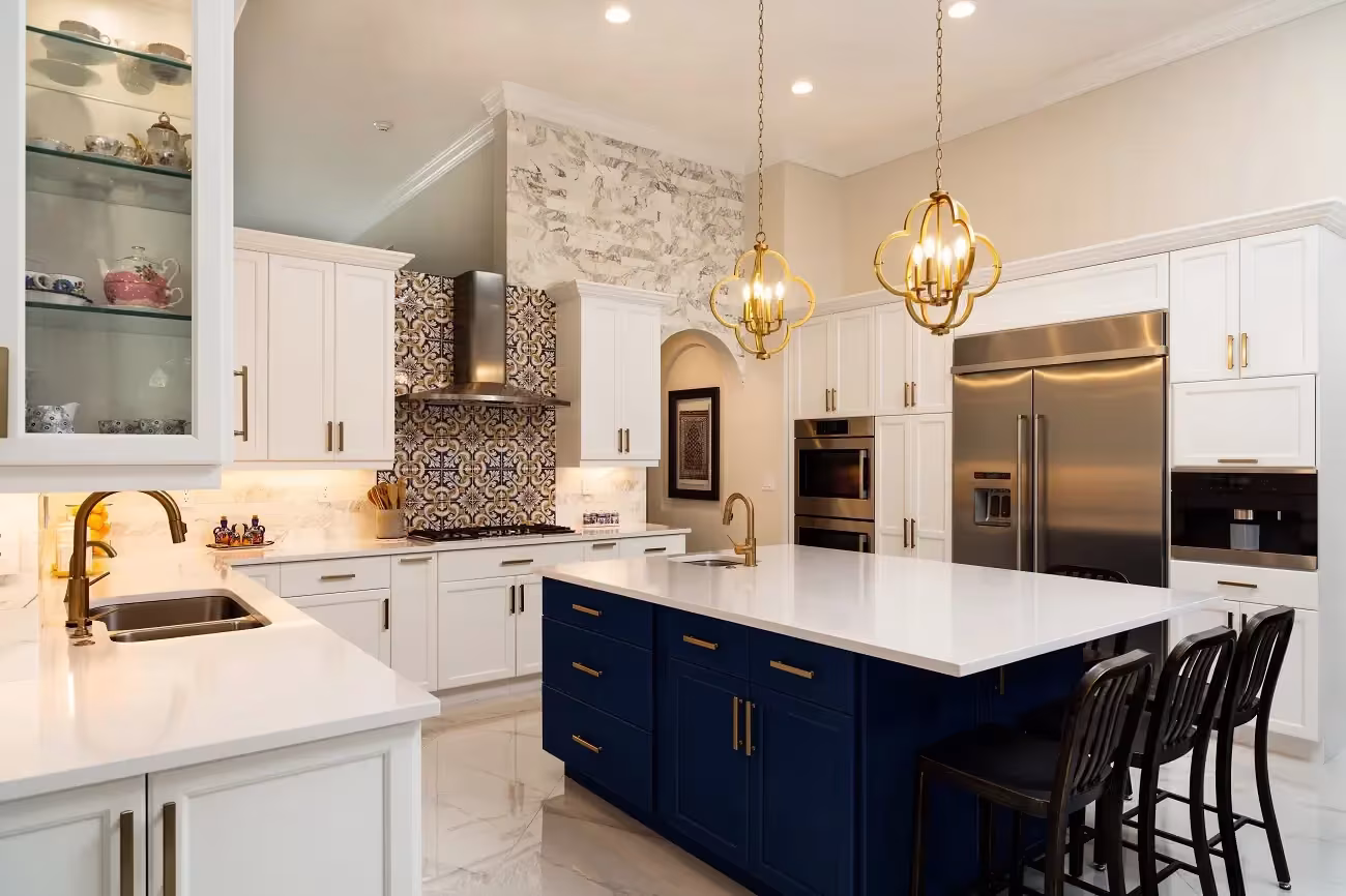White cabinets with a navy island and a brick range hood in Wheeling