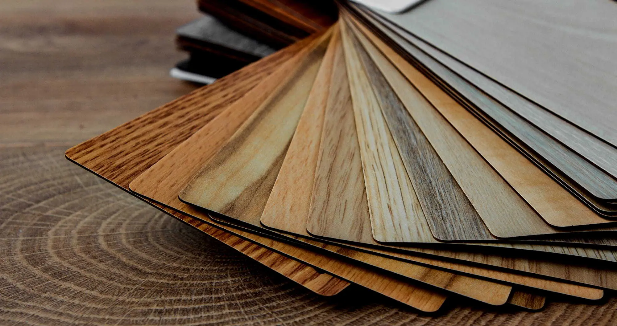 Fan of 3D laminate samples showing woodgrain and stone finishes
