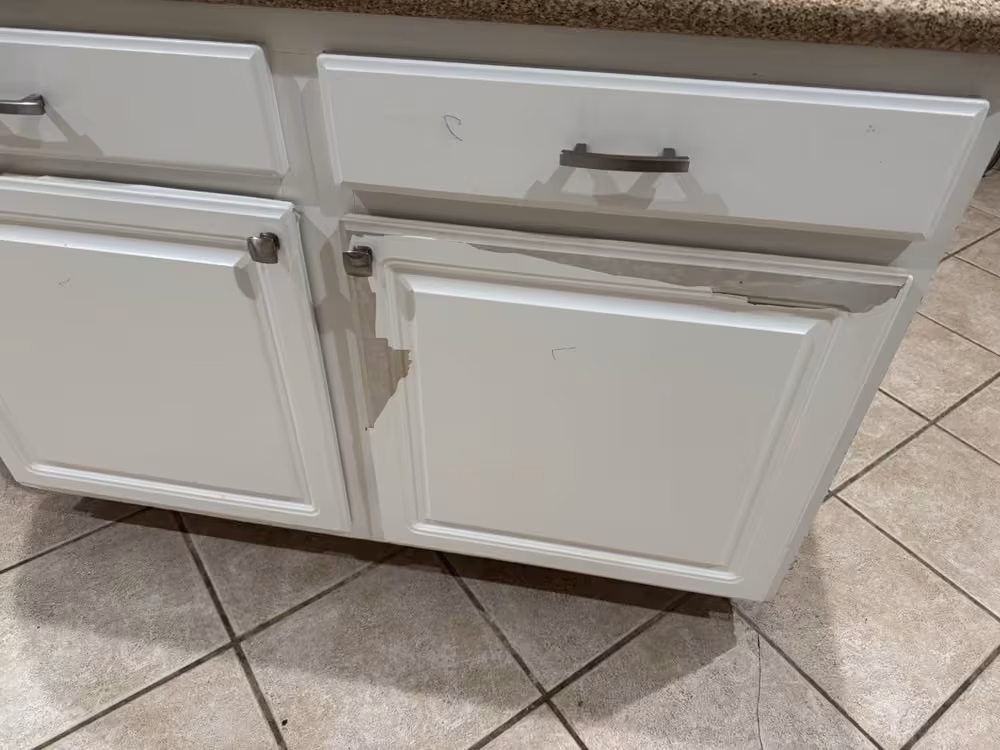 Bubbling thermofoil along the edges of white cabinet doors