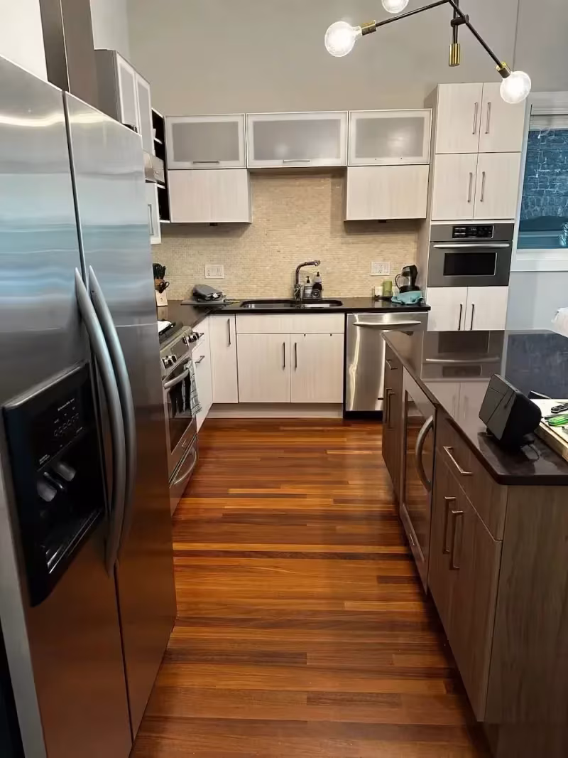 White upper doors and hardwood flooring in the Northbrook kitchen after renewal