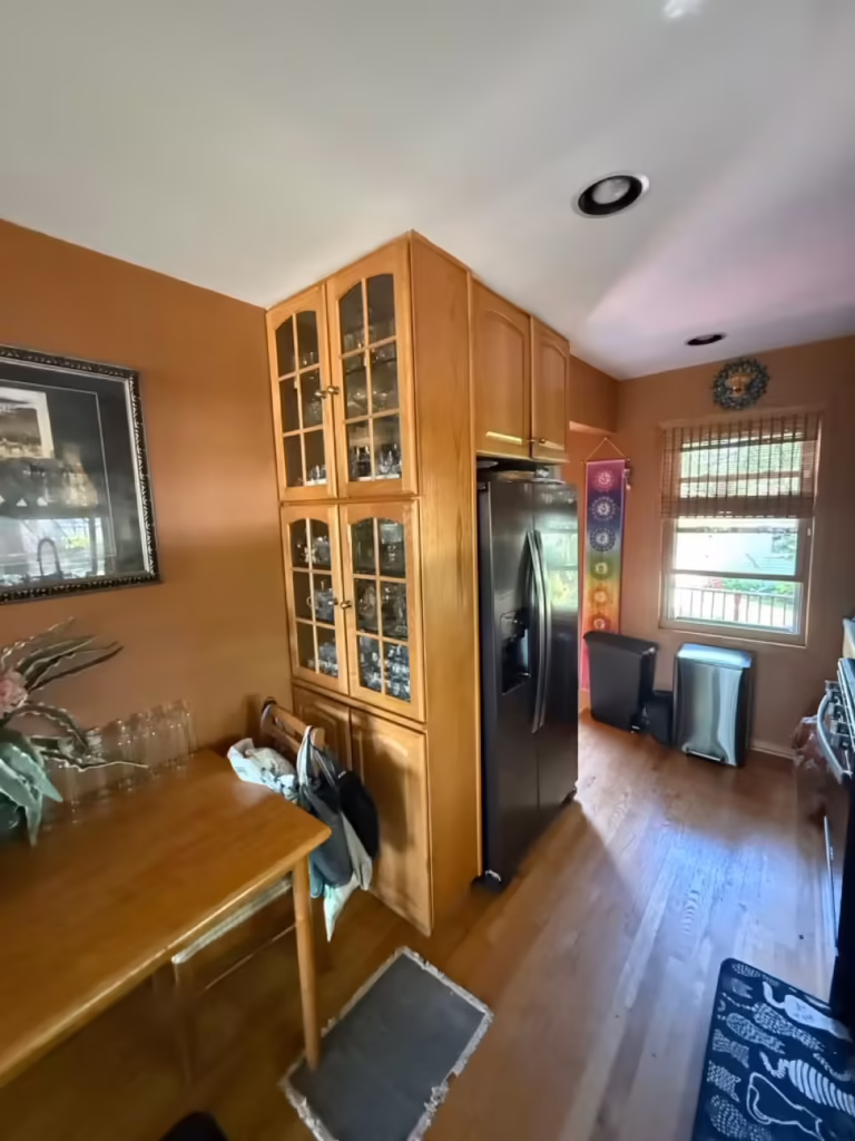 Glass-front oak cabinets and the breakfast table before the kitchen was refaced
