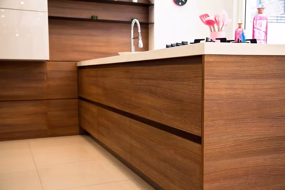 Walnut island with routed grip rails instead of handles