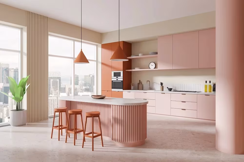 Pastel pink kitchen with a fluted island and terracotta stools