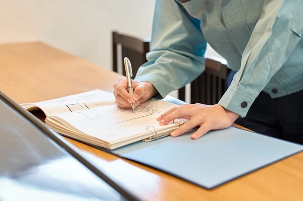 Client signing the paperwork that starts a cabinet refacing project
