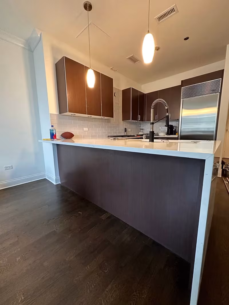 Wood peninsula and cabinets in a Chicago kitchen before refacing
