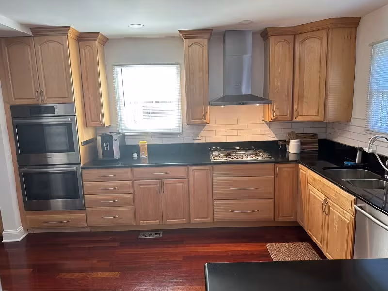 Honey oak cabinets and dark counters in an Arlington Heights kitchen before refacing