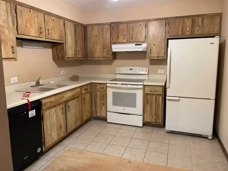 Dated oak cabinets with white appliances in Mount Prospect before the revamp
