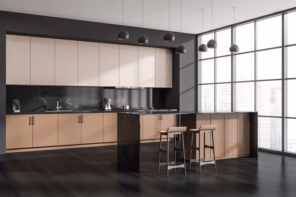 Blush pink upper cabinets above dark base units and a black island