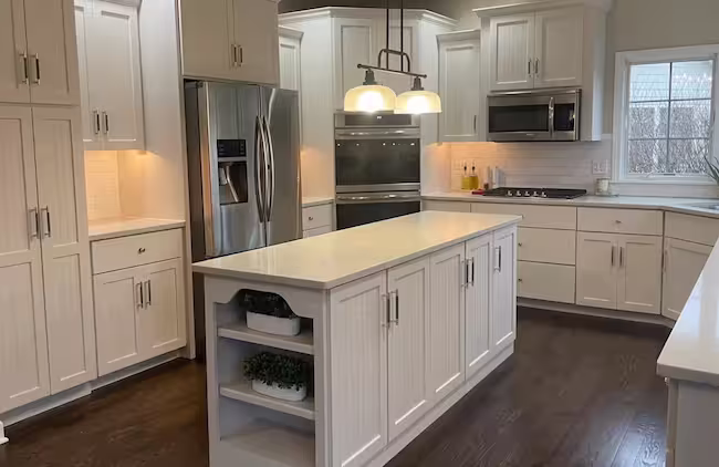 White kitchen with a pendant-lit island after the finishing touches