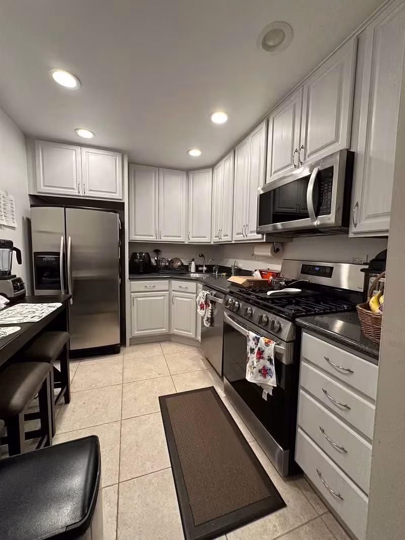 White refaced cabinets and a stainless range in the Arlington Heights kitchen