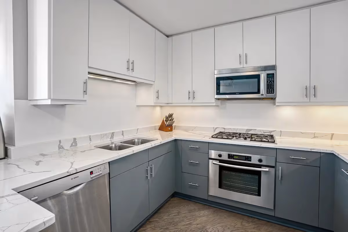 White upper cabinets over gray base units after new doors and drawer fronts