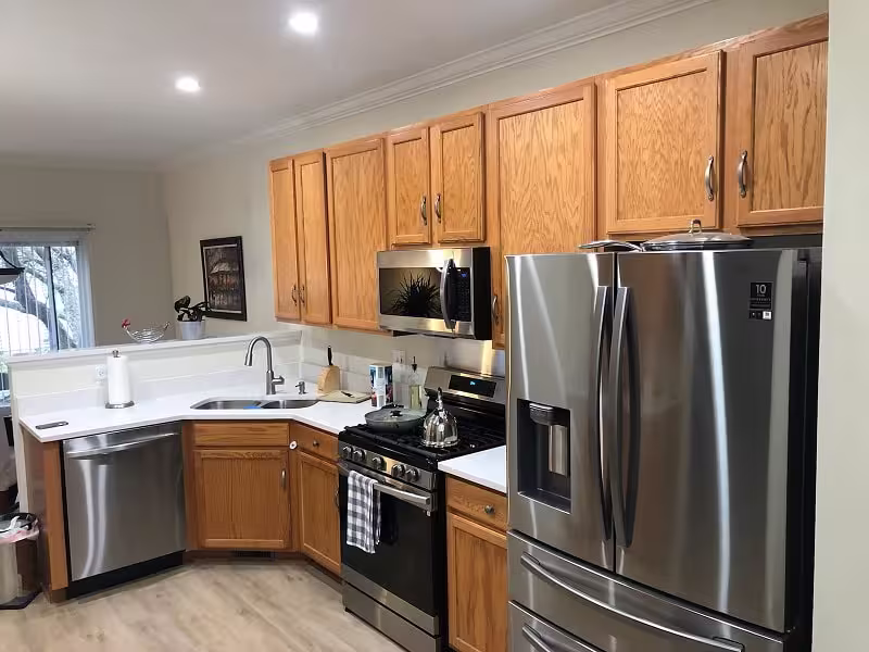 Oak cabinets and stainless appliances before the refacing project