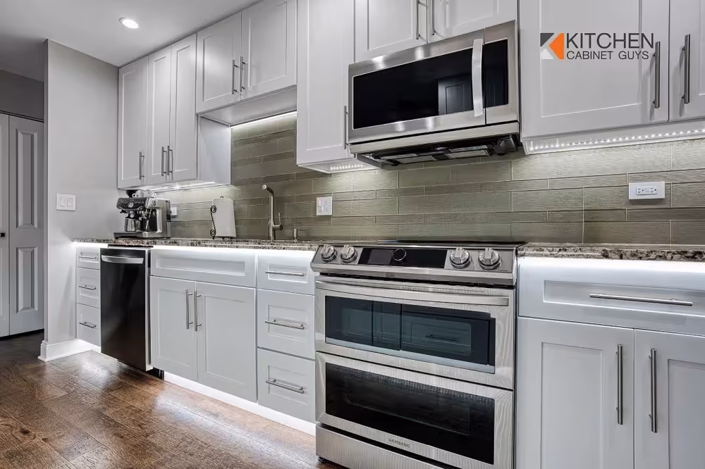 White kitchen with a stainless range and green tile backsplash