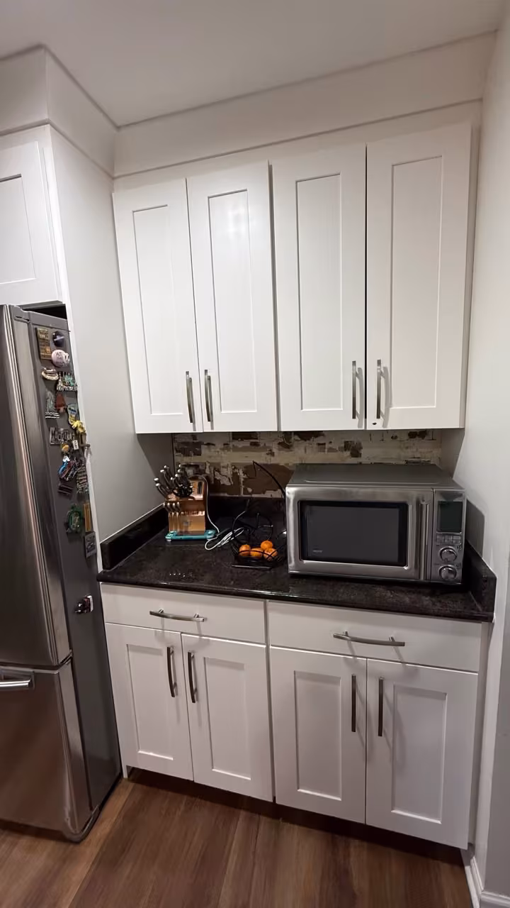 White cabinets and black countertops before natural wood lowers were added