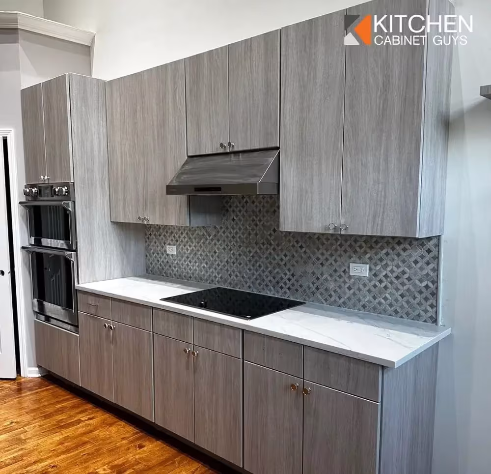 Gray woodgrain cabinets and a mosaic backsplash in a Northbrook kitchen