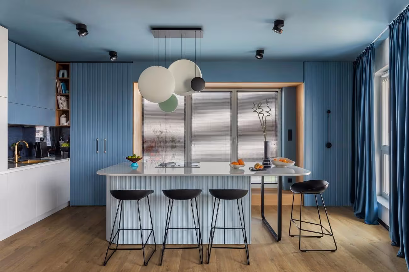 Blue cabinetry and a white island with bar stools in Glendale Heights