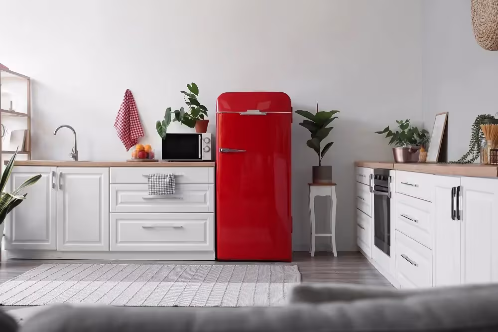White kitchen with a red retro refrigerator as a vintage accent