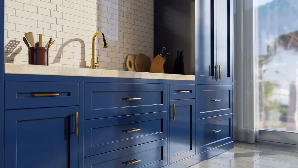 Deep blue cabinets with a brass tap and white brick backsplash