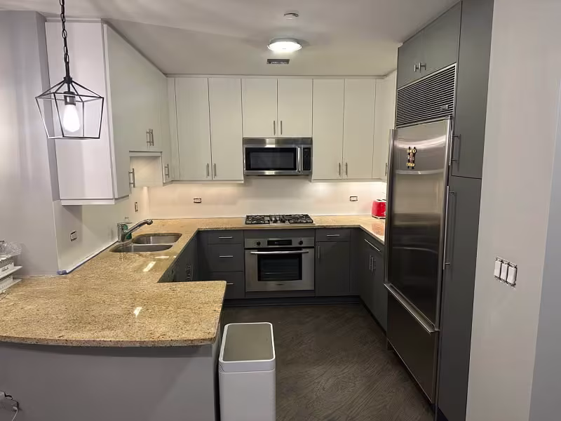 White uppers over gray base cabinets after refacing the cherry kitchen