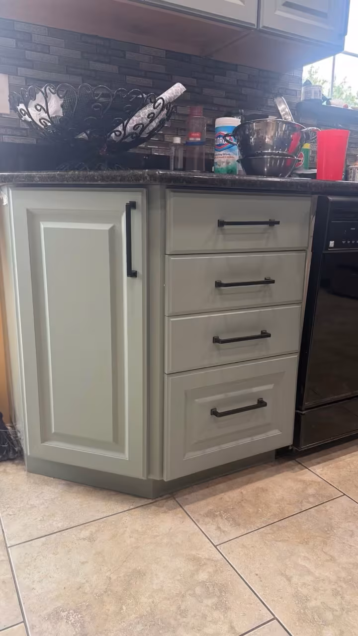 Close view of sage gray drawer fronts and brushed pulls after refacing