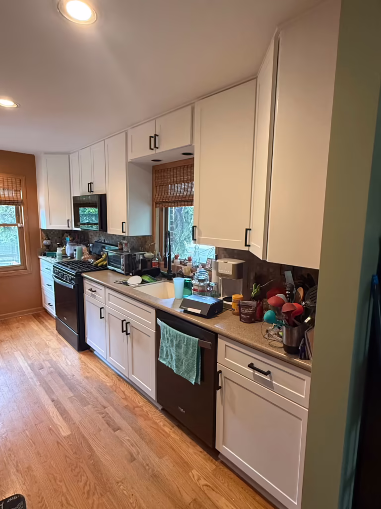 White cabinets and black counters after refacing the honey oak galley