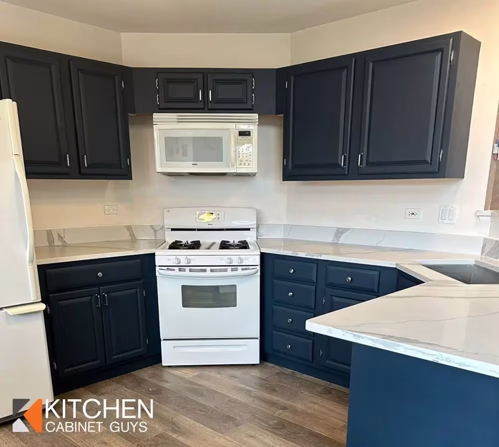 Navy cabinets and white appliances after a bold contrast refacing