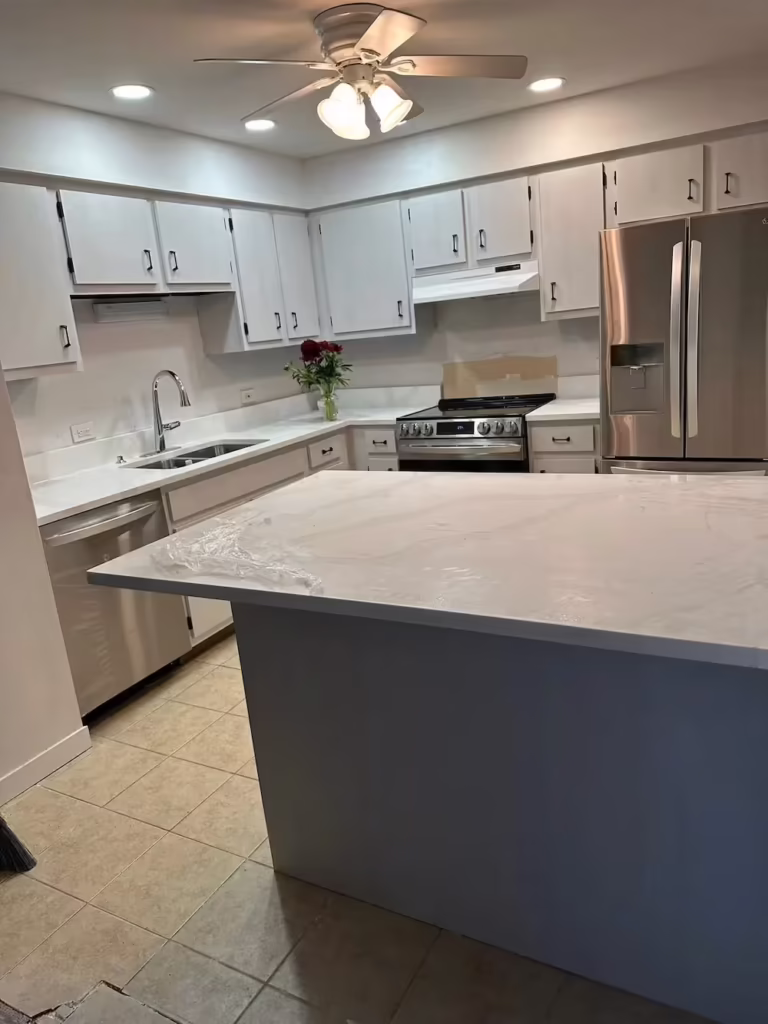 White cabinets and a custom gray island built for the Mount Prospect kitchen