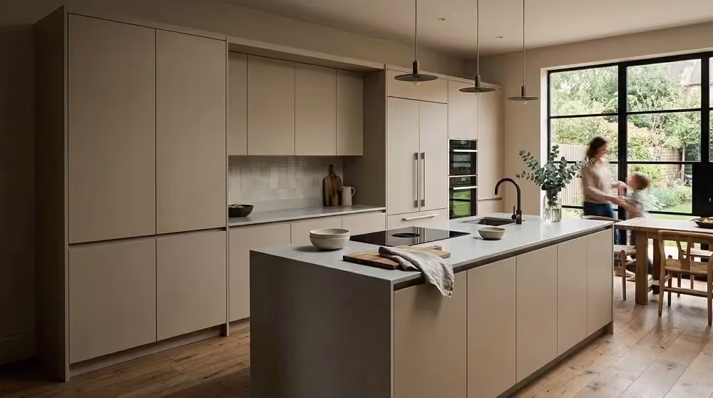 Taupe handleless kitchen with a long low-maintenance island