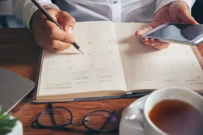 Homeowner noting measurements in a planner before the in-home quote