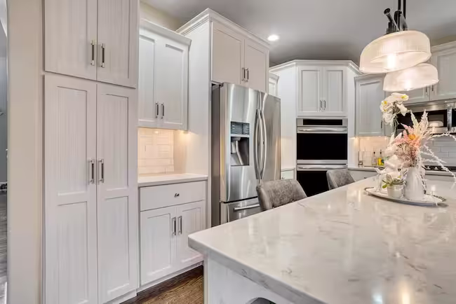 Cream Shaker kitchen with a marble island midway through refacing