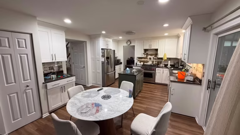 All-white kitchen open to the dining area before two-tone refacing
