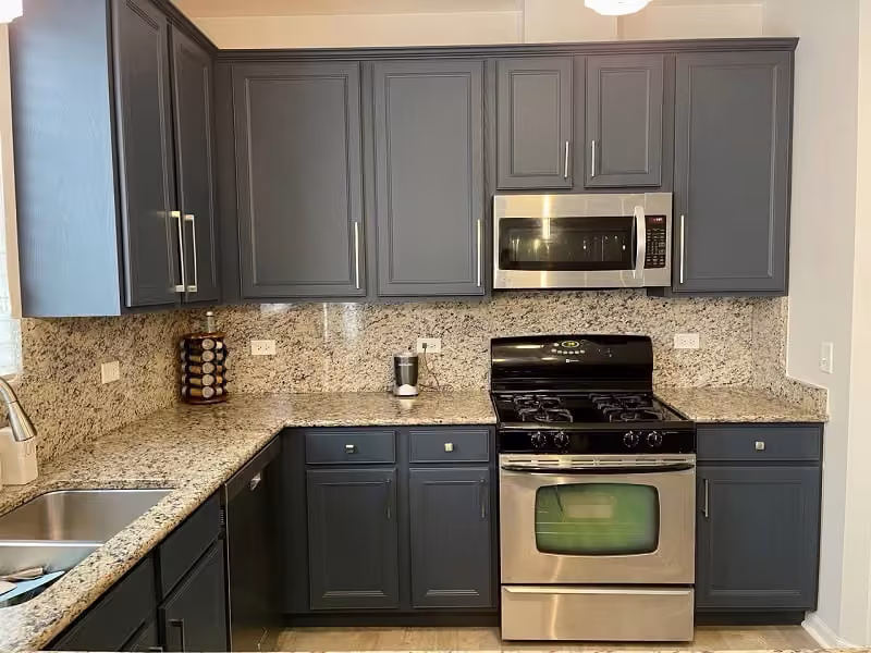 Slate gray refaced cabinets and granite counters in the Naperville kitchen