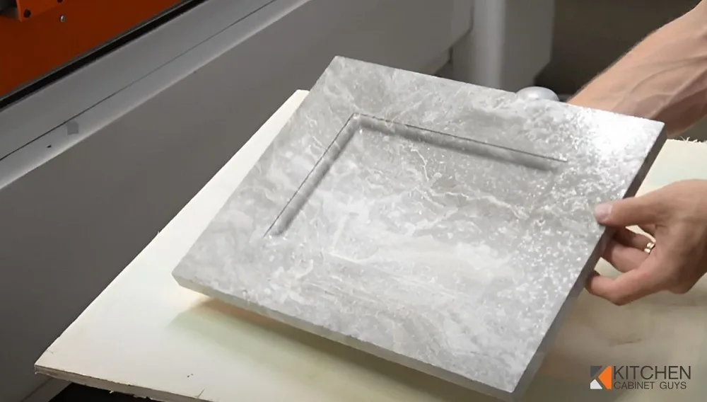 Marble-look cabinet door checked and wrapped before shipping