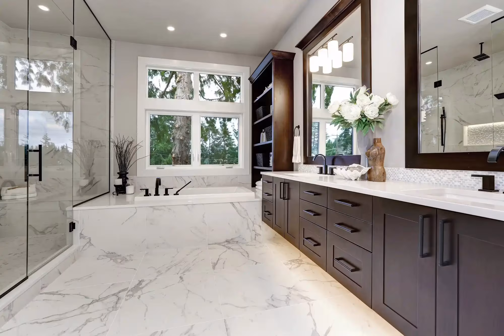 Bathroom with a dark wood vanity and marble tile flooring